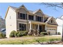 Beautiful two-story house with a lush green lawn and a convenient two-car garage at 4012 Grand Park Ne Dr, Suwanee, GA 30024