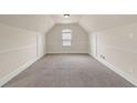 Bright bonus room with vaulted ceilings, neutral carpet, and natural light at 4249 Caveat Ct, Fairburn, GA 30213