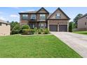 Beautiful brick home with green lawn and a two-car garage at 4249 Caveat Ct, Fairburn, GA 30213