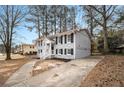 Charming two-story home with black shutters and a large concrete driveway at 5257 Orly Ter, Atlanta, GA 30349