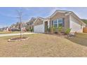 Attractive brick home with neat landscaping, a two-car garage, and a cozy, suburban appeal at 1991 Vidalia Ct, Dacula, GA 30019