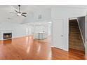 Open concept living area features hardwood floors, a fireplace, and connects to the kitchen at 395 Shadetree Ln, Lawrenceville, GA 30044
