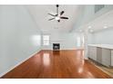 Spacious living room with vaulted ceilings, hardwood floors, and a cozy fireplace at 395 Shadetree Ln, Lawrenceville, GA 30044