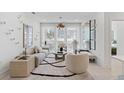 Comfortable living room features a stylish rug, contemporary decor, and bright natural light from large windows at 775 Juniper Ne St # 111, Atlanta, GA 30308