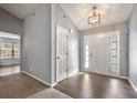 Bright foyer with hardwood floors, vaulted ceiling, and a front door with sidelights and transom window at 1851 Millwood Park Ct, Buford, GA 30518