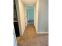 Hallway leads to carpeted bedrooms, with a glimpse of the kitchen at 2958 Parc Lorraine, Lithonia, GA 30038