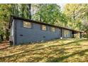Charming single-story home with a painted brick facade, shutters, and landscaped yard at 5726 Southwick Sw Ct, College Park, GA 30349