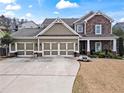 Charming two-story home with a three-car garage and a beautifully landscaped front yard at 108 Summer Breeze Ln, Canton, GA 30114