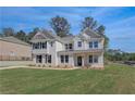 Attractive two-story house with white siding, black shutters, and a neatly kept lawn at 141 Frontier Way, Mcdonough, GA 30253