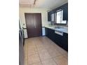 Kitchen featuring tiled flooring, dark cabinetry, and stainless steel appliances at 1125 Durrell St, Austell, GA 30106