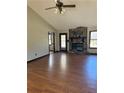 Spacious living room featuring beautiful wood floors, a ceiling fan, and stone fireplace at 1125 Durrell St, Austell, GA 30106