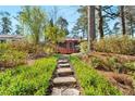 Lush backyard with a stone path leading to a house with a screened-in porch at 1175 Kingsley Ne Cir, Atlanta, GA 30324