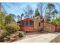 Charming home featuring unique wood shingles and a screened-in porch for outdoor living at 1175 Kingsley Ne Cir, Atlanta, GA 30324