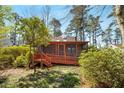 Charming screened sunroom entrance with ramp and stairs, surrounded by lush trees and green foliage at 1175 Kingsley Ne Cir, Atlanta, GA 30324