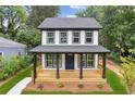 Beautiful two-story home with black framed windows and a cozy front porch at 1158 Welch Sw St, Atlanta, GA 30310