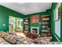 Comfortable living room featuring a decorative fireplace, built-in bookshelves, and hardwood floors at 333 Drexel Ave, Decatur, GA 30030