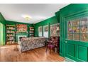 Inviting living room with rich green walls, hardwood floors, built-in bookshelves, and tapestry art at 333 Drexel Ave, Decatur, GA 30030