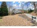 Large two-story home with a landscaped yard and a long, curved driveway at 130 Cauley Club Ct, Johns Creek, GA 30097