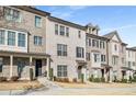 Beautiful townhouse with light brick facade, dark shutters, and covered front porch at 4358 White Spruce Aly, Doraville, GA 30360