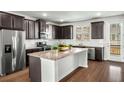 Modern kitchen featuring stainless steel appliances, granite countertops, and dark wood cabinets at 4358 White Spruce Aly, Doraville, GA 30360
