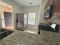 Open-concept kitchen boasts granite countertops, stainless steel appliances, and seamless flow to living areas at 585 Mcwilliams Se Rd # 2602, Atlanta, GA 30315