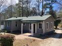 Back of home with a covered porch and brick flooring at 8090 Colquitt St, Douglasville, GA 30134