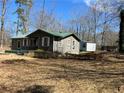 View of the back of the home and the partially wooded lot at 8090 Colquitt St, Douglasville, GA 30134