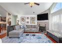 Open living room with fireplace, large windows, and hardwood flooring at 1203 Cascade Park Sw Dr, Atlanta, GA 30331
