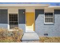 Close-up of the home's charming front door featuring a bright, inviting yellow paint at 1798 Giben Rd, Atlanta, GA 30315