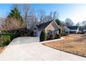 Well-maintained home with a long driveway and attached garage at 2425 Pemberton Pt, Buford, GA 30519