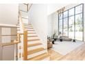 A bright and airy living room with high ceilings, large windows, and a wooden staircase at 2624 Forrest Ne Way, Atlanta, GA 30305