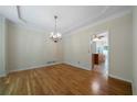 Elegant dining room with hardwood floors, a chandelier, and an open doorway to another room at 5960 Camelia Dr, Douglasville, GA 30135