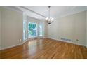 Bright dining room with hardwood floors, large bay window, chandelier, and neutral paint at 5960 Camelia Dr, Douglasville, GA 30135