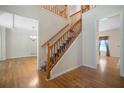 Spacious foyer with hardwood floors, a staircase with carpet runner, and views into adjacent rooms at 5960 Camelia Dr, Douglasville, GA 30135