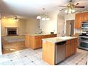 Spacious kitchen with double islands, granite countertops, stainless steel appliances, and tile flooring at 5960 Camelia Dr, Douglasville, GA 30135