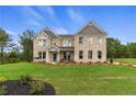 Stunning brick two-story home featuring a lush green lawn, classic architecture, and inviting front entrance at 133 Frontier Way, Mcdonough, GA 30253