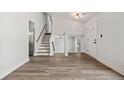 Bright living room featuring hardwood floors, staircase, and a white front door at 2111 Glenwood Downs Dr, Decatur, GA 30035
