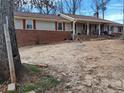 A ranch-style home with brick and vinyl siding, plus a covered porch and an expansive front yard at 5865 Leah Lane Ln, Powder Springs, GA 30127