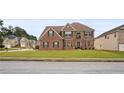 Charming brick two-story home with manicured lawn and traditional architectural details at 106 Dustin Dr, Stockbridge, GA 30281
