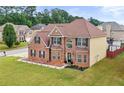 Beautiful two-story brick home with well-maintained landscaping and an inviting entrance at 106 Dustin Dr, Stockbridge, GA 30281