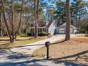 View of a charming home with a detached garage, as seen from the driveway at 150 Forest Ridge Ct, Lawrenceville, GA 30046
