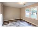 Bright bedroom featuring durable gray-toned laminate flooring and a large window at 391 Oak Dr, Social Circle, GA 30025