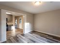 Bright dining area featuring durable gray-toned laminate flooring and views into kitchen at 391 Oak Dr, Social Circle, GA 30025
