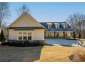 Inviting home with dormers and a covered porch, set on a well-maintained lawn at 105 Crown Ln, Woodstock, GA 30188