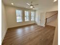 Bright bedroom featuring three large windows, hardwood floors and a ceiling fan at 2257 Addington Way # 56, Atlanta, GA 30319