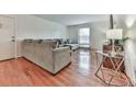 Inviting living room with hardwood floors and large sectional, perfect for relaxing and entertaining guests at 6700 Roswell Rd # 24E, Atlanta, GA 30328