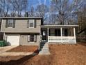 Charming two-story home featuring a front porch and attached garage at 885 Hemingway Rd, Stone Mountain, GA 30088