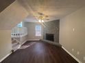 Cozy living room with a stone fireplace and hardwood floors at 885 Hemingway Rd, Stone Mountain, GA 30088