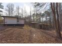 View of the backyard with mature trees and additional storage shed at 4289 Post Rd, Winston, GA 30187