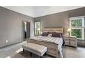 Main bedroom with tray ceiling, neutral colors, carpet floors, and ample natural light at 635 Piping Rock Pt, Lawrenceville, GA 30043